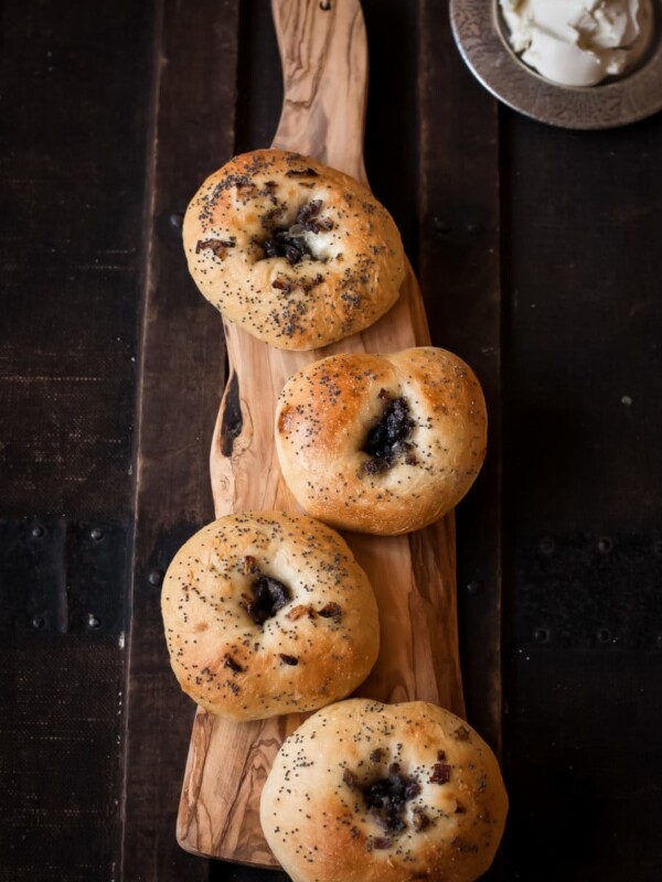 Four buns on a wooden serving board