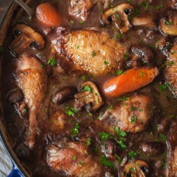 top down view of coq au vin with carrots and mushrooms