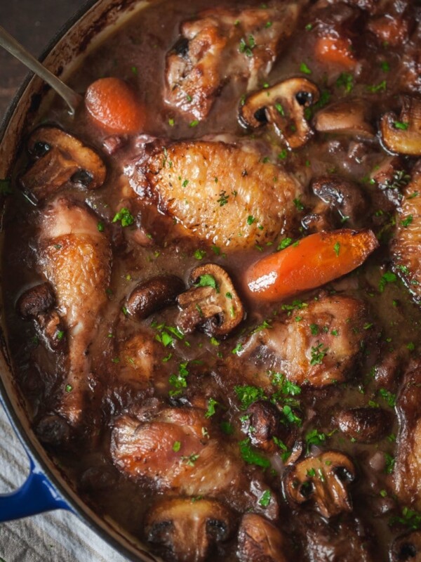top down view of coq au vin with carrots and mushrooms
