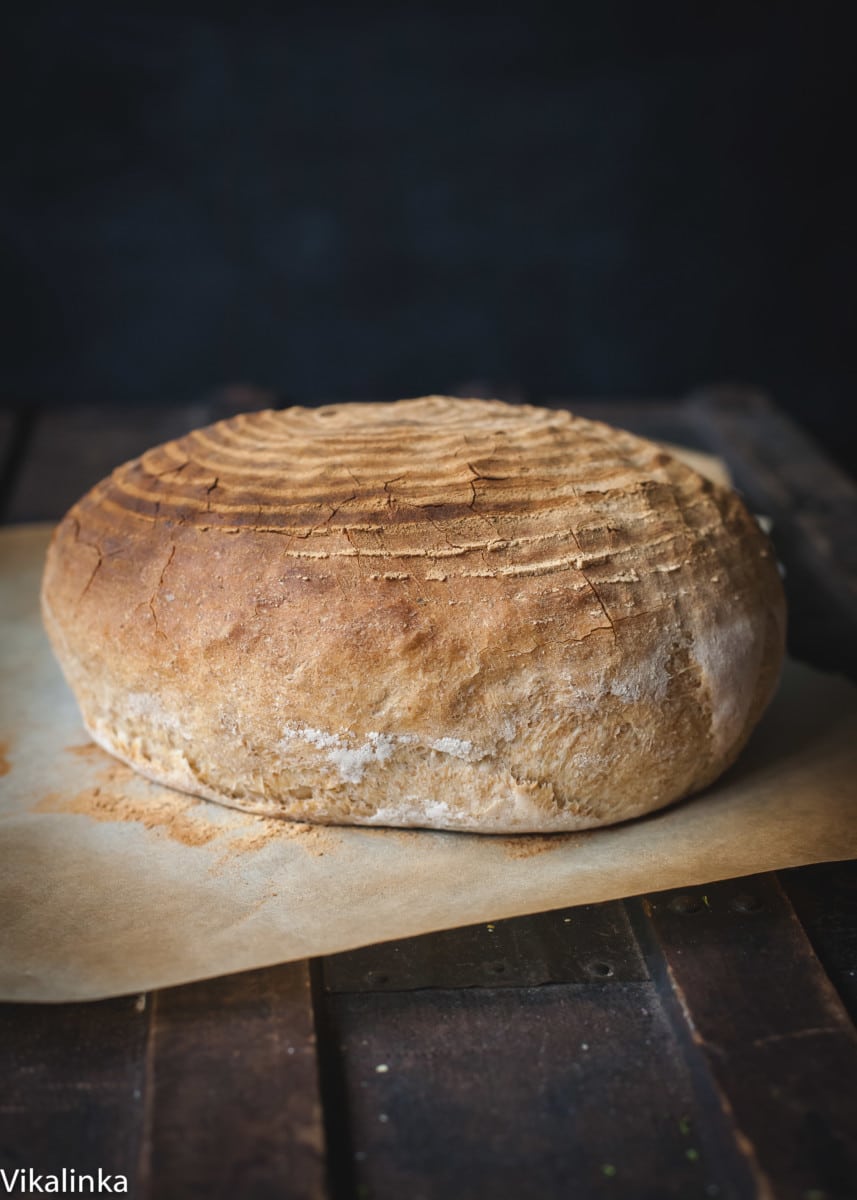 Loaf of rosemary spelt bread on a cutting board