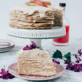Piece of crepe cake with full cake in background