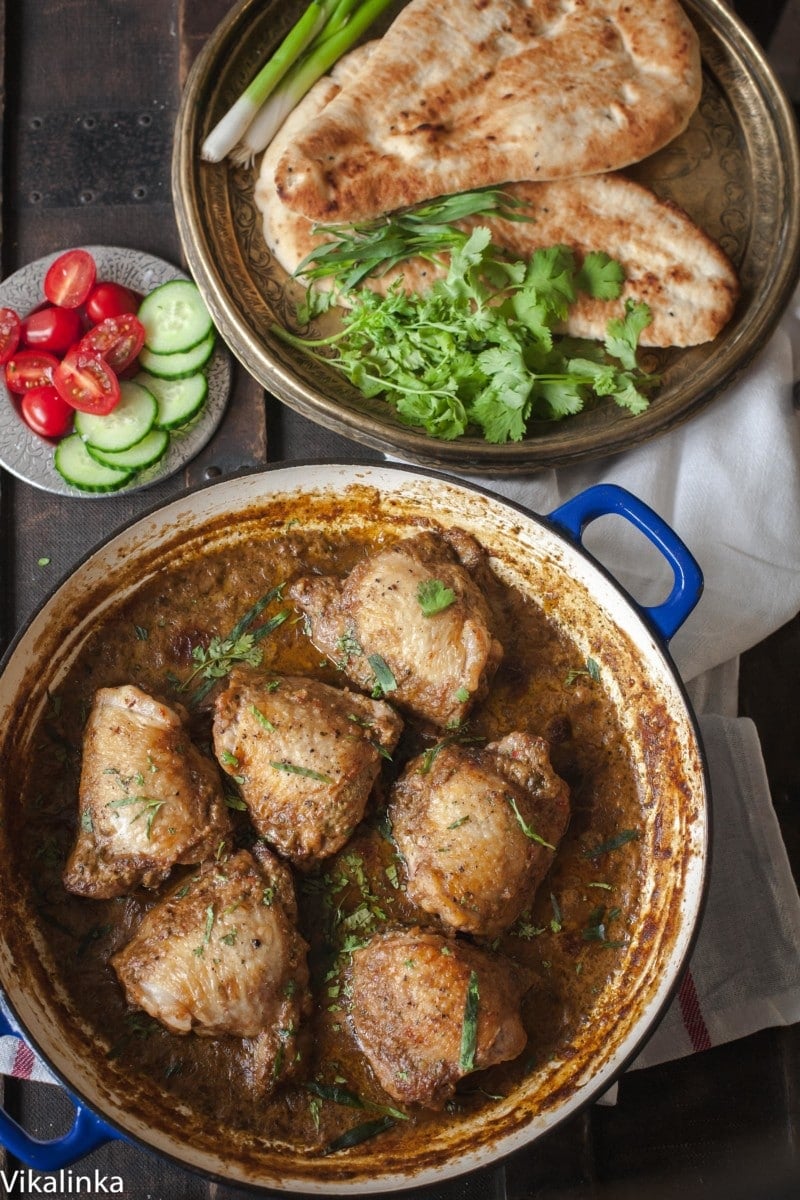 Top down of chicken in garlic walnut sauce in a pan