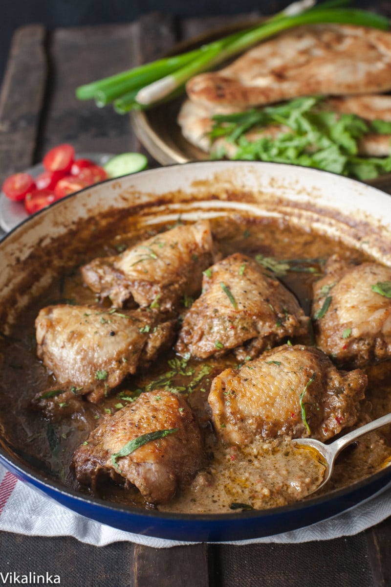 Close up of chicken in garlic walnut sauce