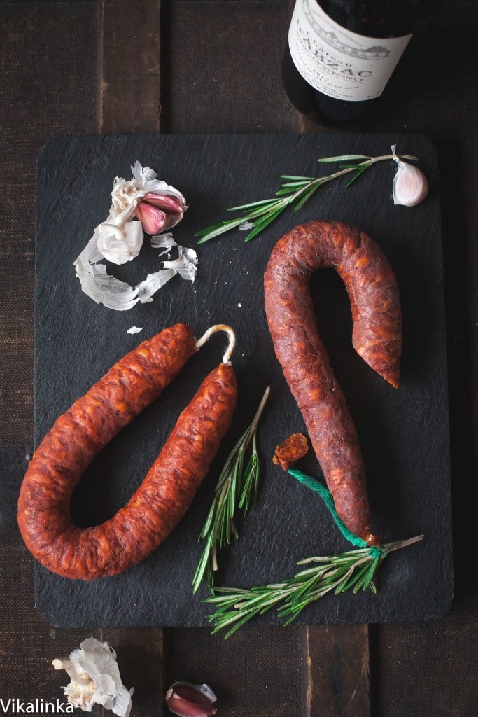 Cutting board with two lengths of chorizo