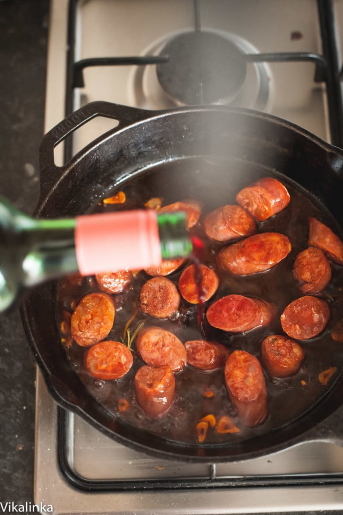 Frying pan with chorizo and wine poured in
