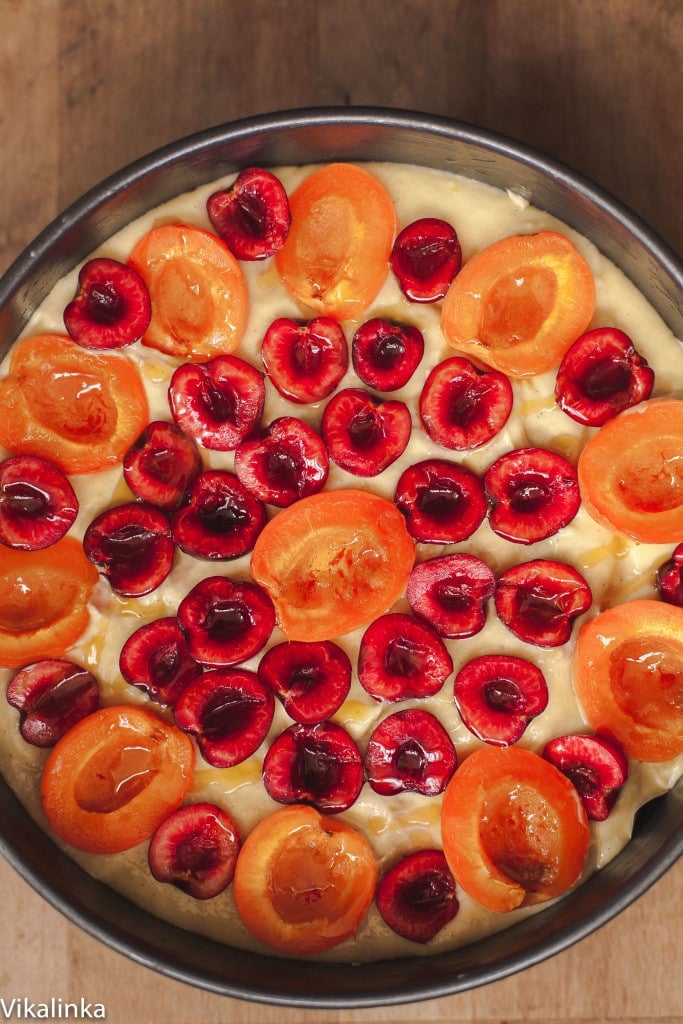 Top down view of the unbaked cake with fruit on top