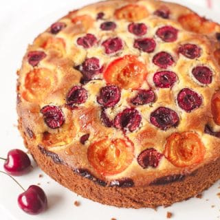 Cake on a stand with two cherries