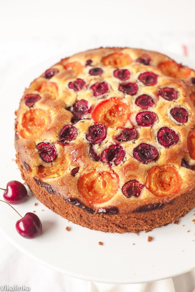 Cake on a stand with two cherries