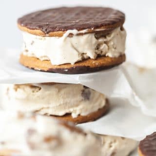 Prepared cappuccino daim ice cream sandwiches stacked with parchment paper