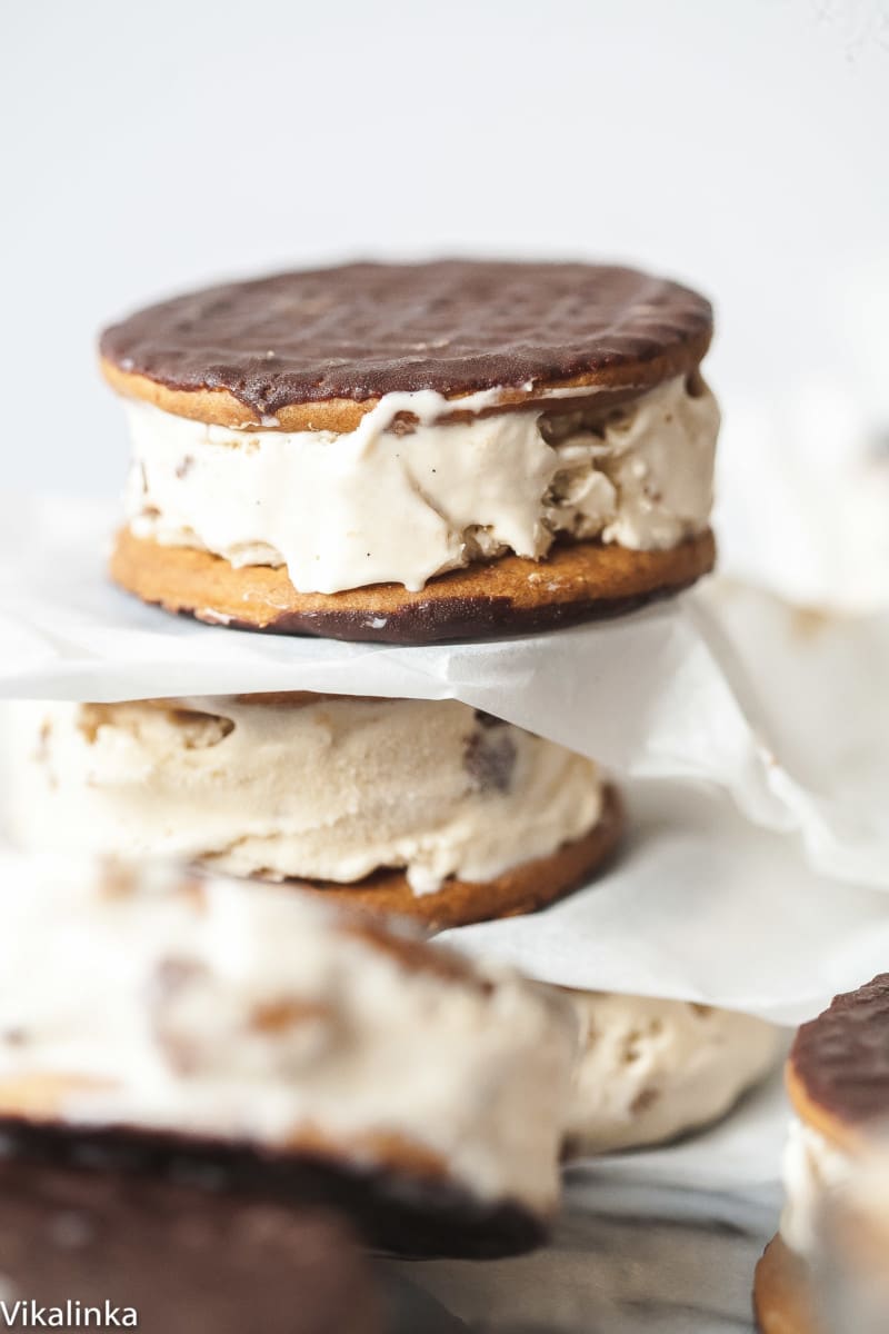 Prepared cappuccino daim ice cream sandwiches stacked with parchment paper