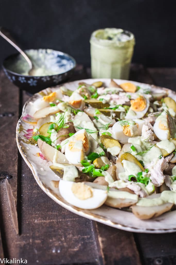 Potato salad with dressing in the background