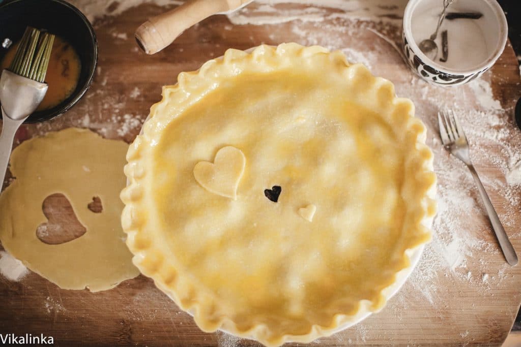 Unbaked pie showing top crust brushed with beaten egg