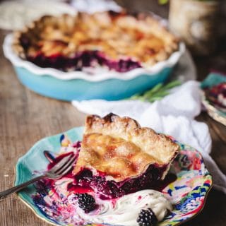 Piece of wild blackberry pie with dollop of creme fraiche