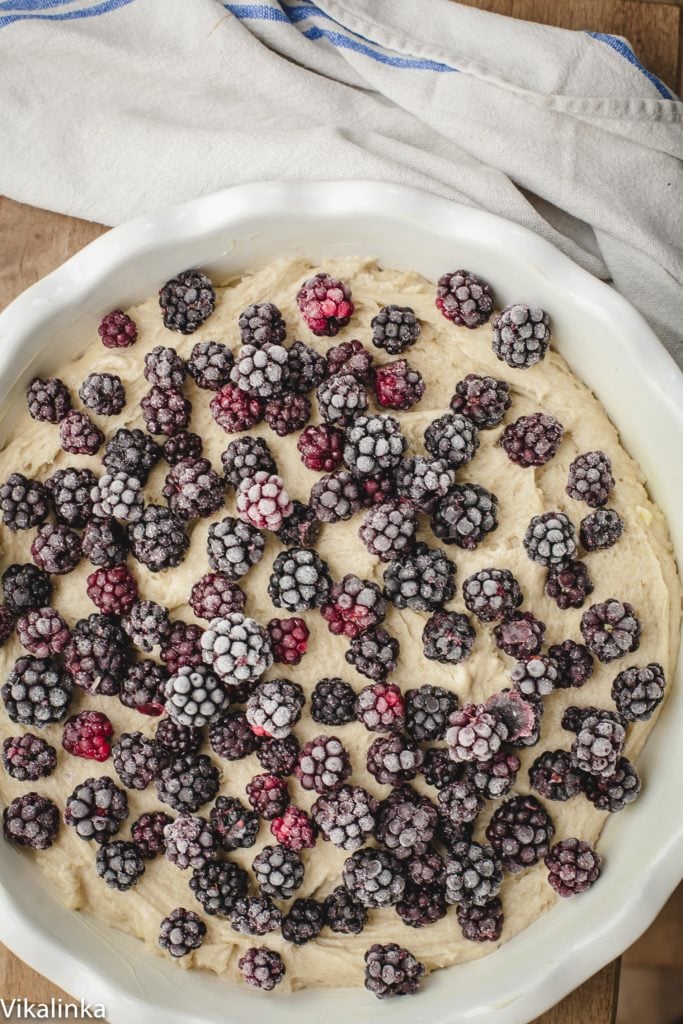 Batter in baking dish topped by berries