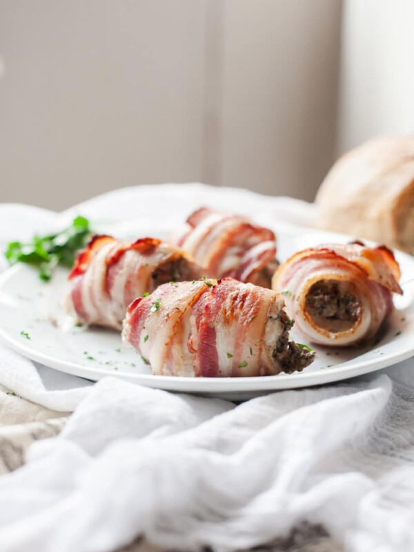Close up of bacon wrapped chicken thighs on a plate