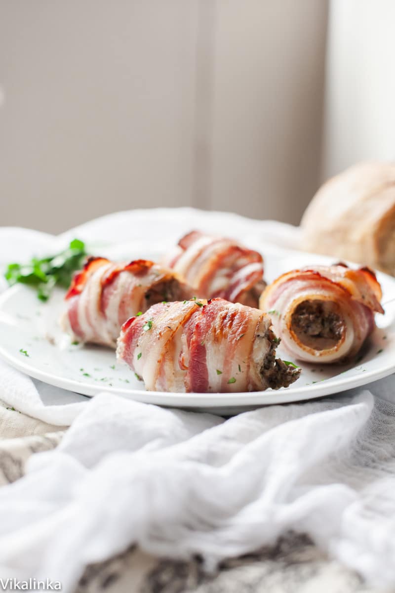 Close up of bacon wrapped chicken thighs on a plate