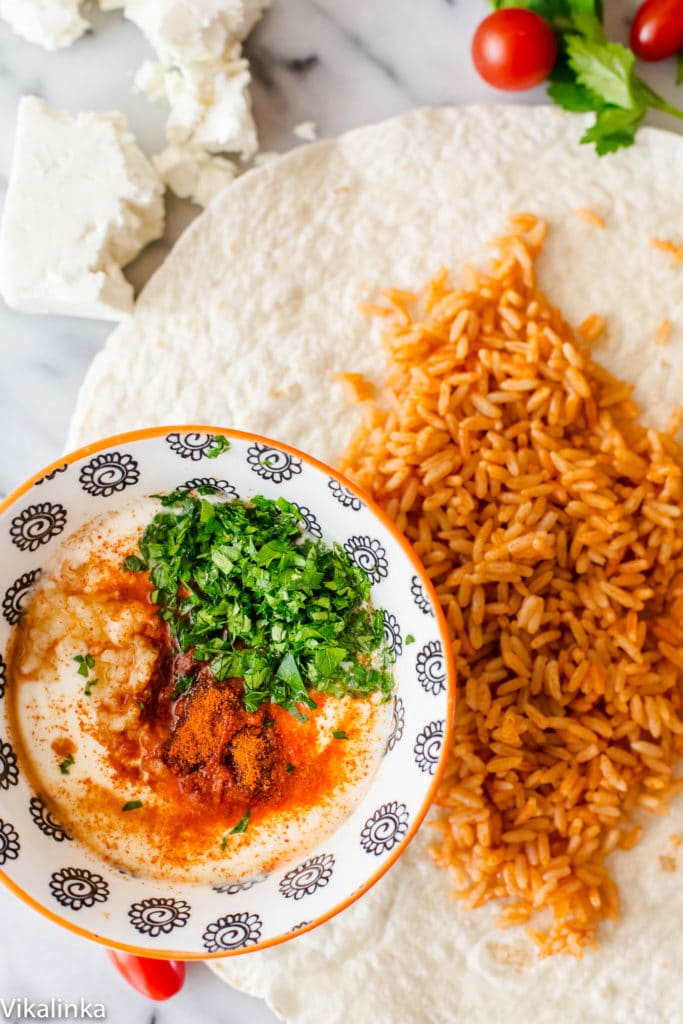 Wrap with peri peri rice with bowl showing topping mixture