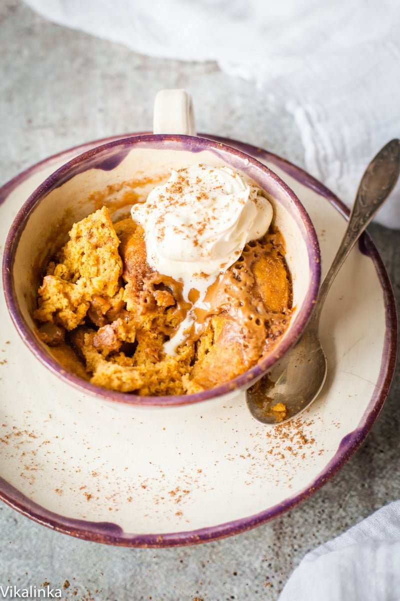 close up of Spiced Pumpkin Molten Mug Cake in a mug with a spoon