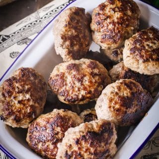 meat patties in white enamel dish