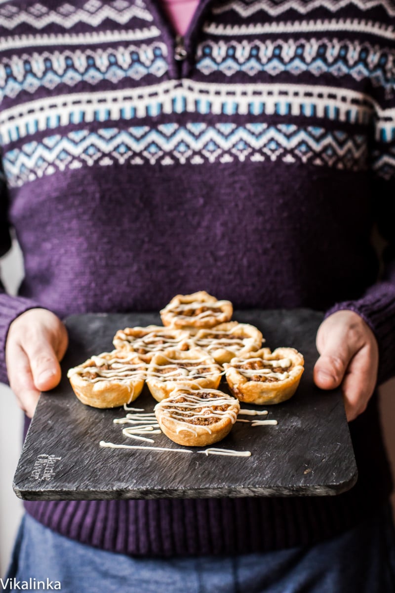 Butter Tarts-flaky pastry tartlets filled with delicious golden custard, raisins and walnuts.