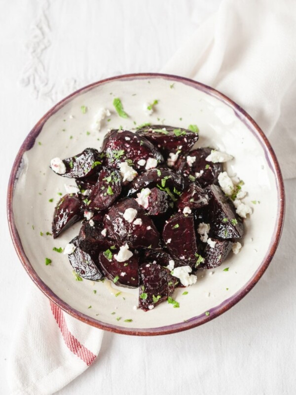 Top down view of beets with goats cheese and mint on a plate