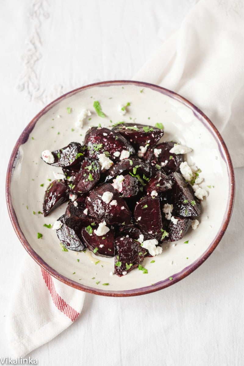 Top down view of beets with goats cheese and mint on a plate