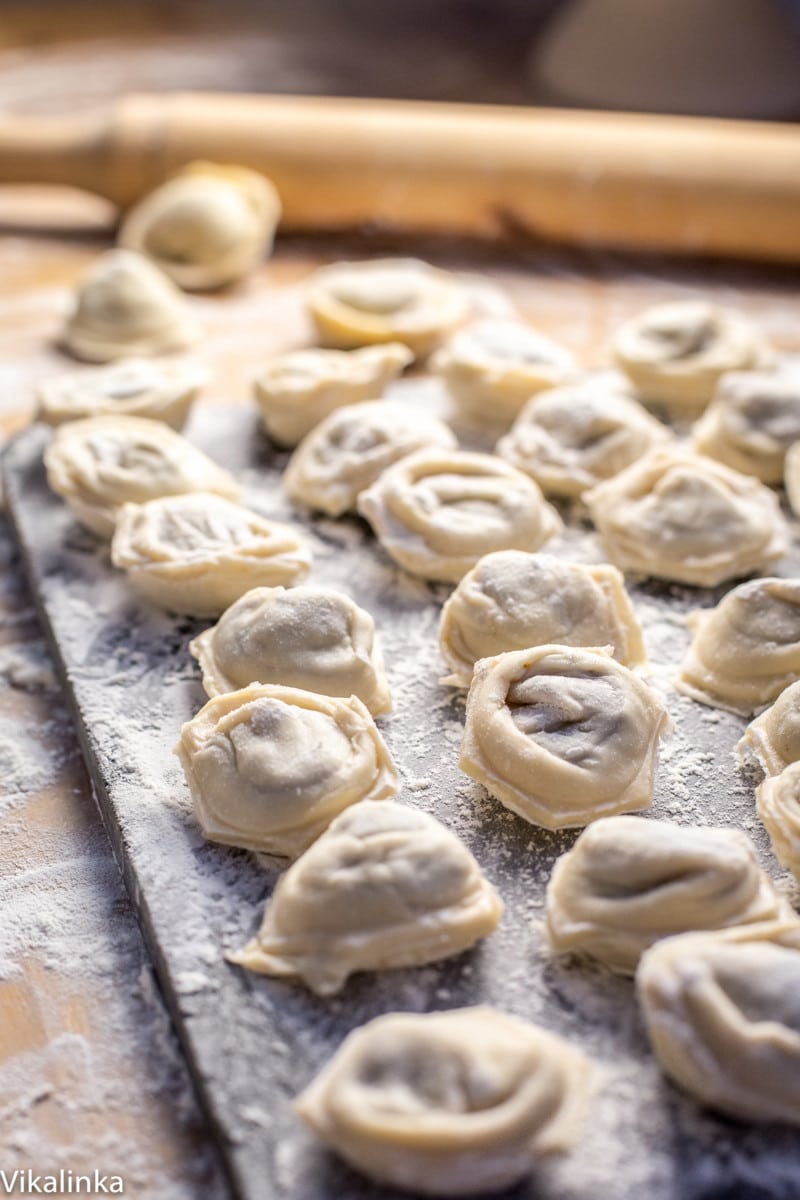 uncooked dumplings on a floured surface