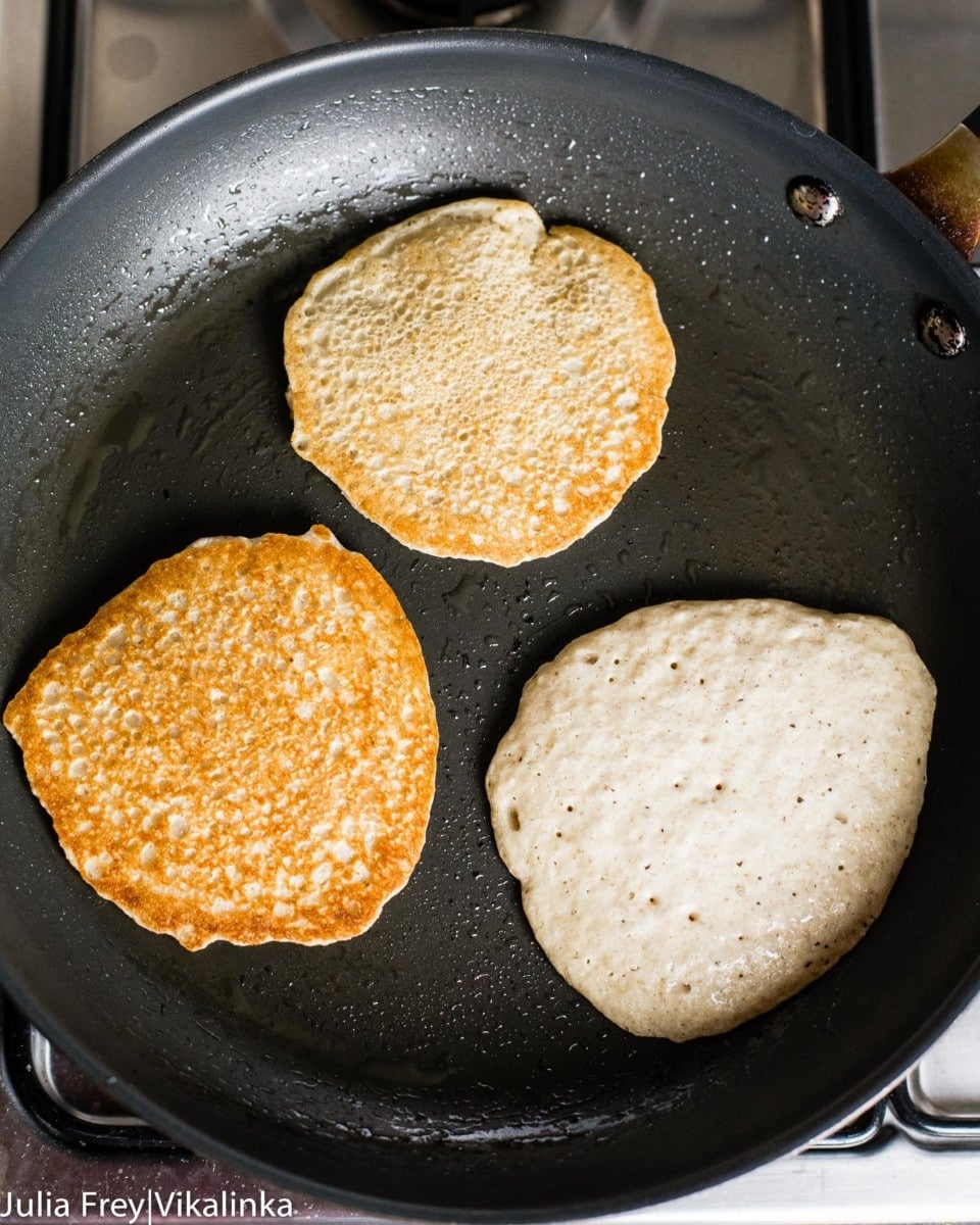 oat pancakes in a pan being cooked