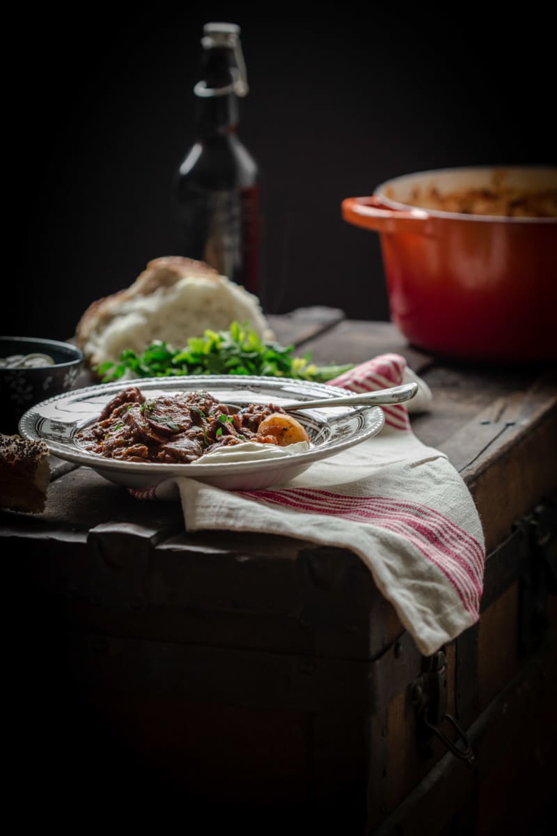 bowl of solyanka as part of a rustic table setting