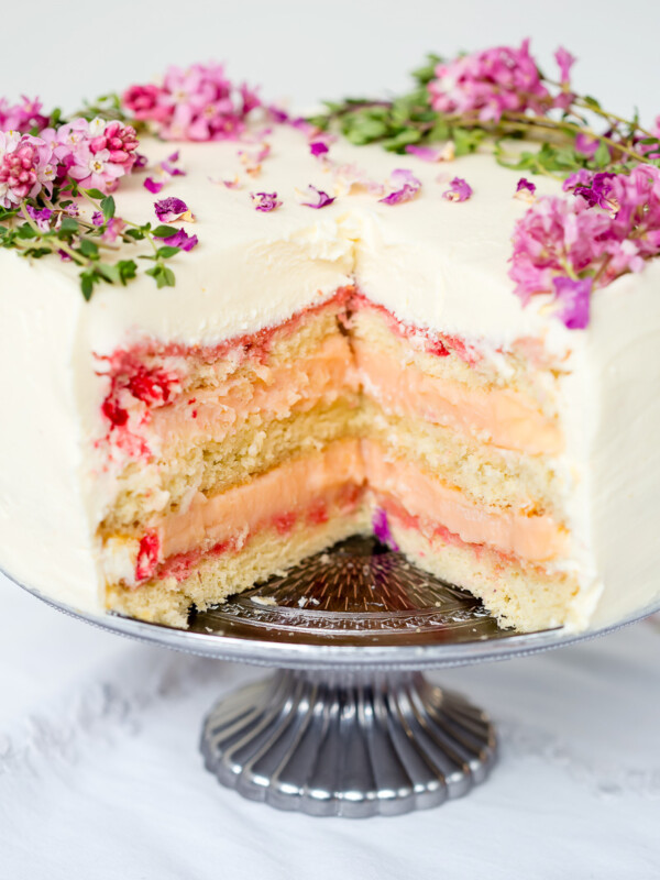 layer cake with a slice cut our exposing vanilla sponge and rhubarb curd filling