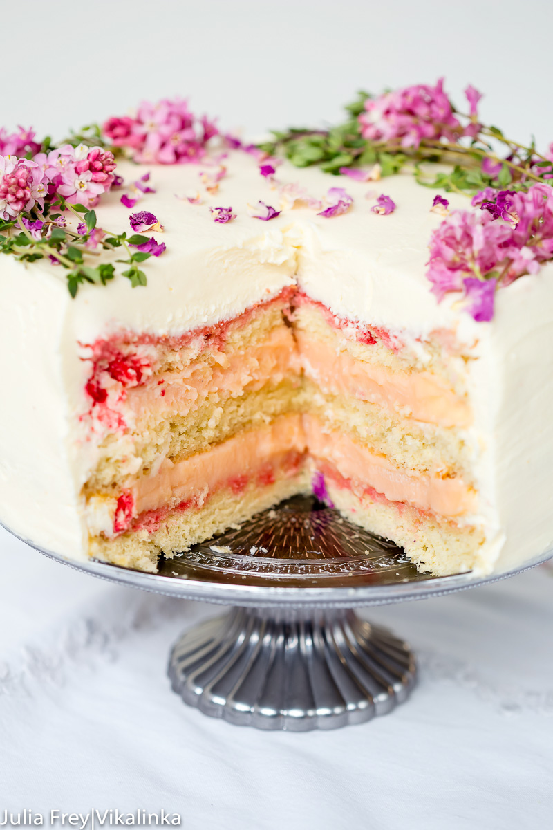 layer cake with a slice cut our exposing vanilla sponge and rhubarb curd filling