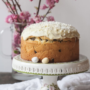 Kulich with white icing on a cake stand