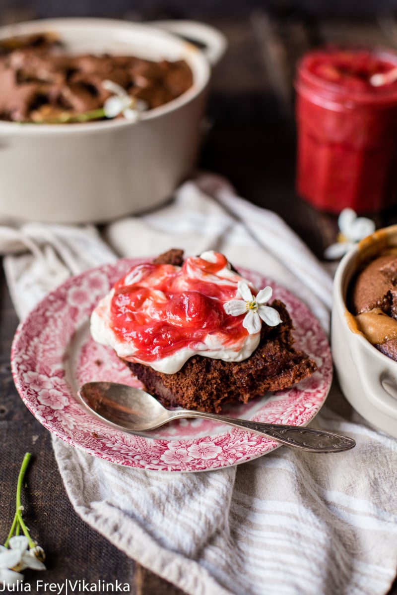 close up of chocolate fudge cake with stewed rhubarb