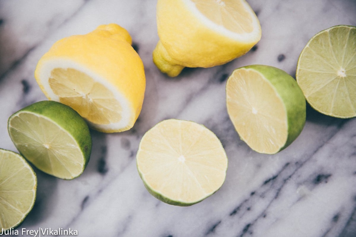 Cut lemons and limes on a marble slab