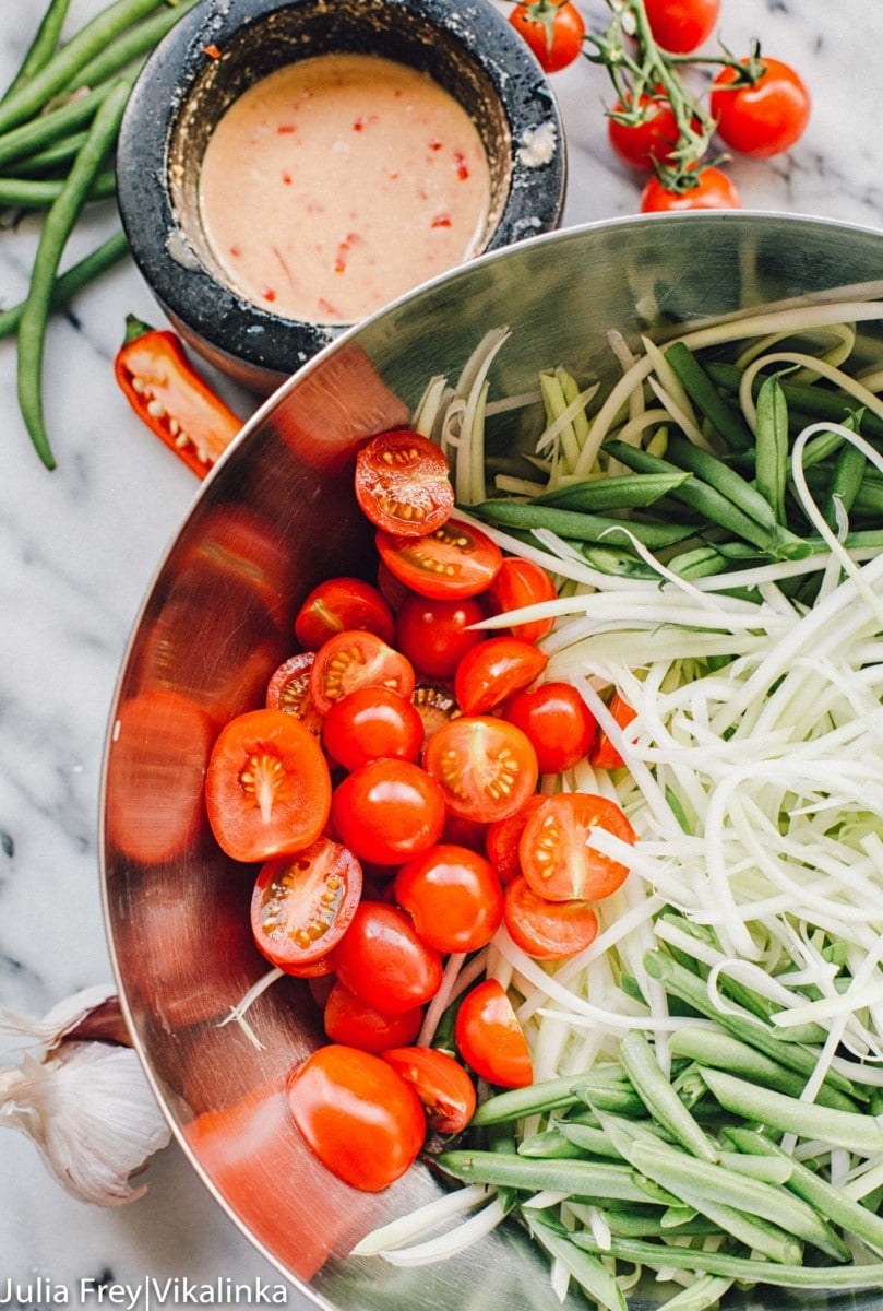 Mixing bowl with ingredients such as tomatoes, peas, beans and bean sprouts