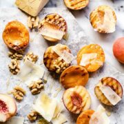 Apricots and peaches showing grill marks and other ingredients on marble