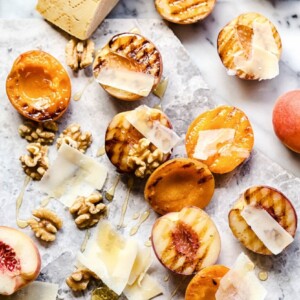 Apricots and peaches showing grill marks and other ingredients on marble