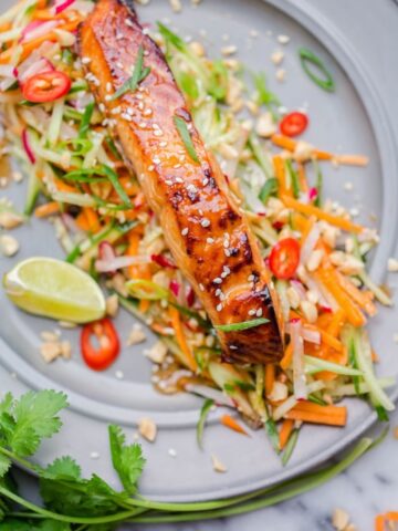 Asian glazed salmon on top of carrot and cucumber slaw with lime and chillies.