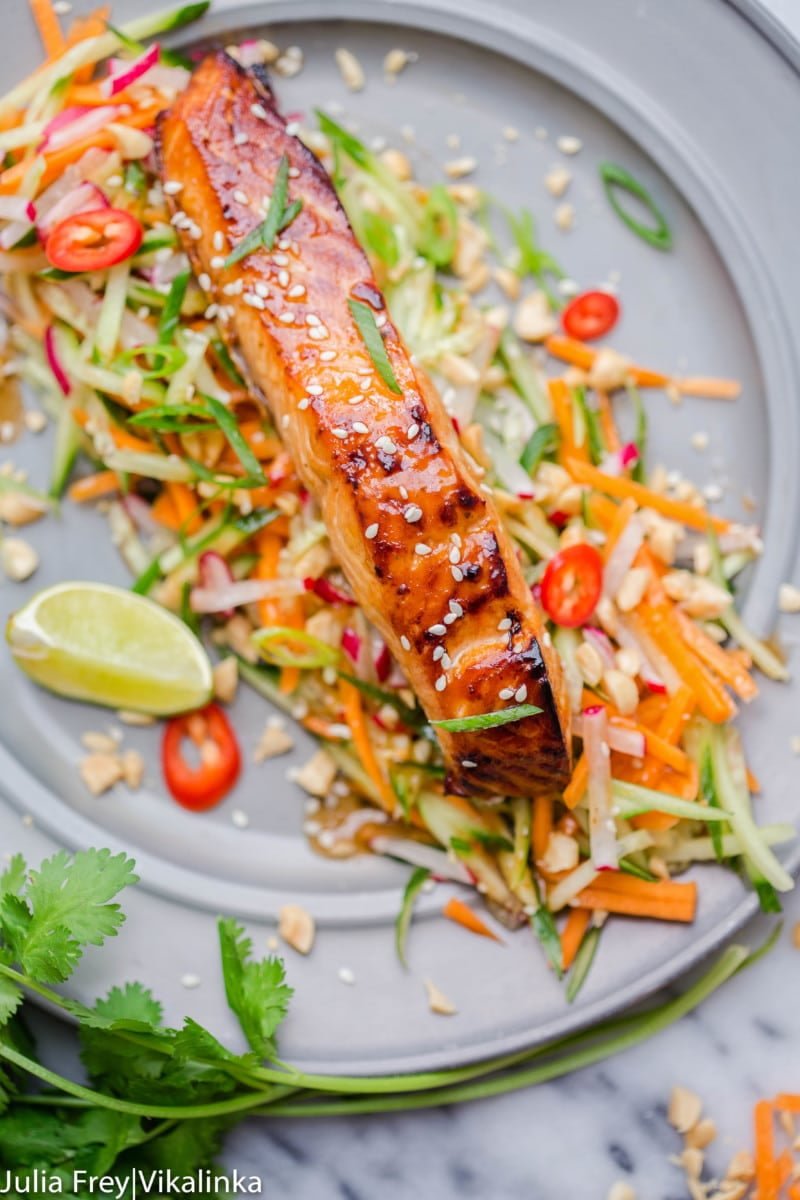 Asian glazed salmon on top of carrot and cucumber slaw with lime and chillies. 