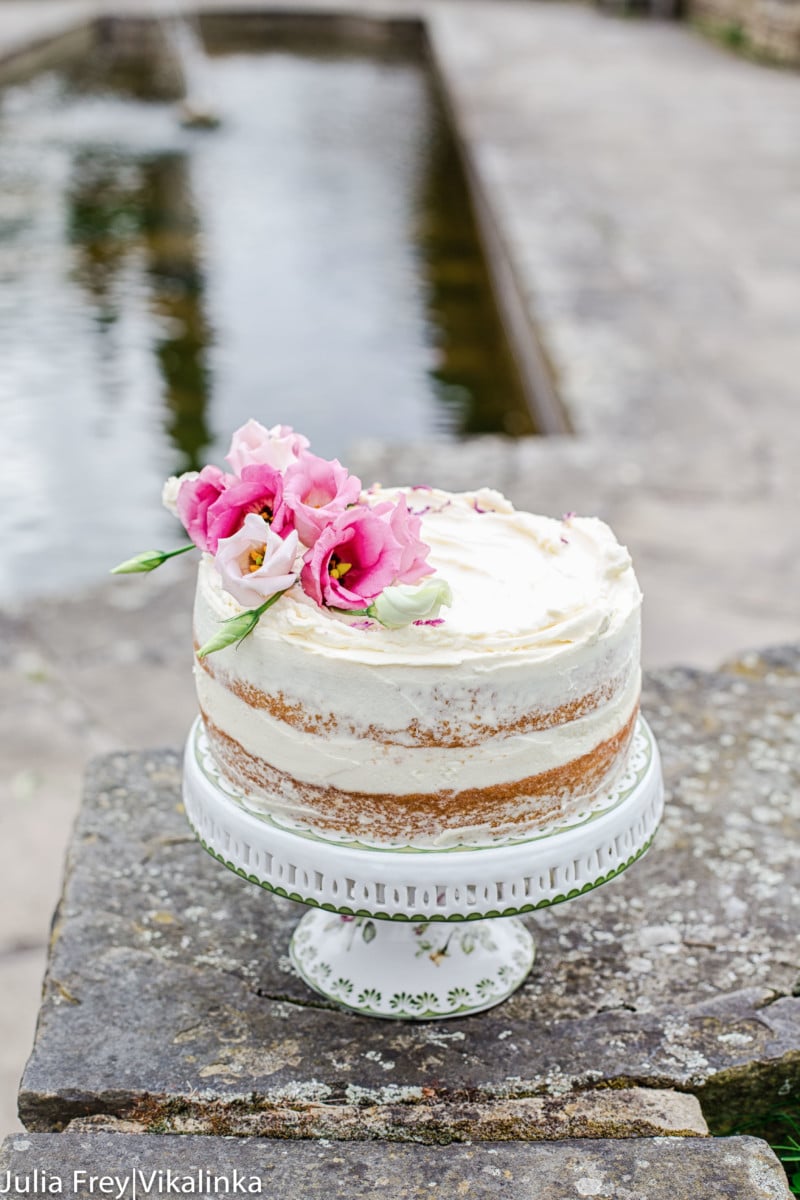 Cake and stand on a wall with pond in the background