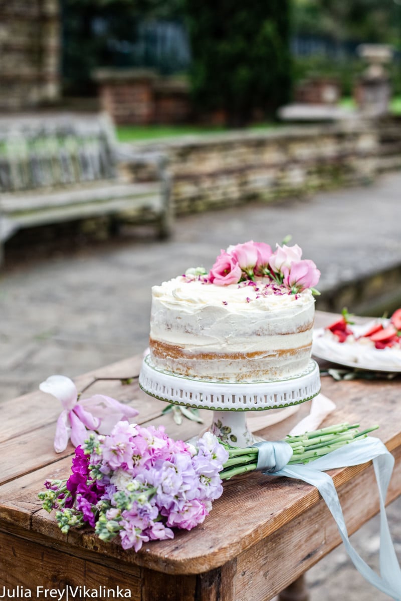 Cake on a table with bouquet of flowers
