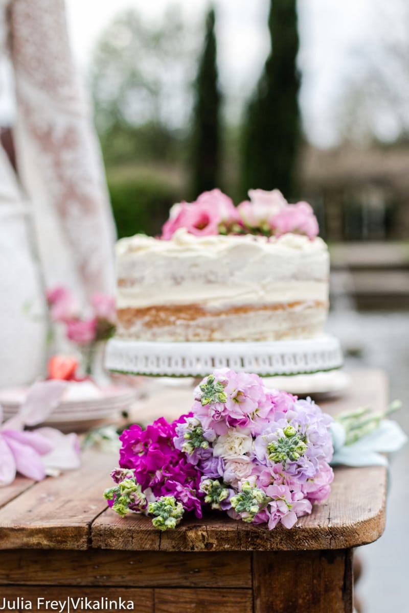 Side view of cake with flowers on a table