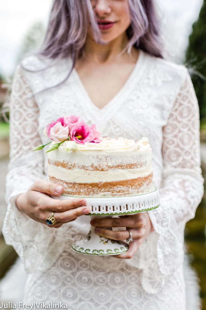 Model carrying cake on a stand