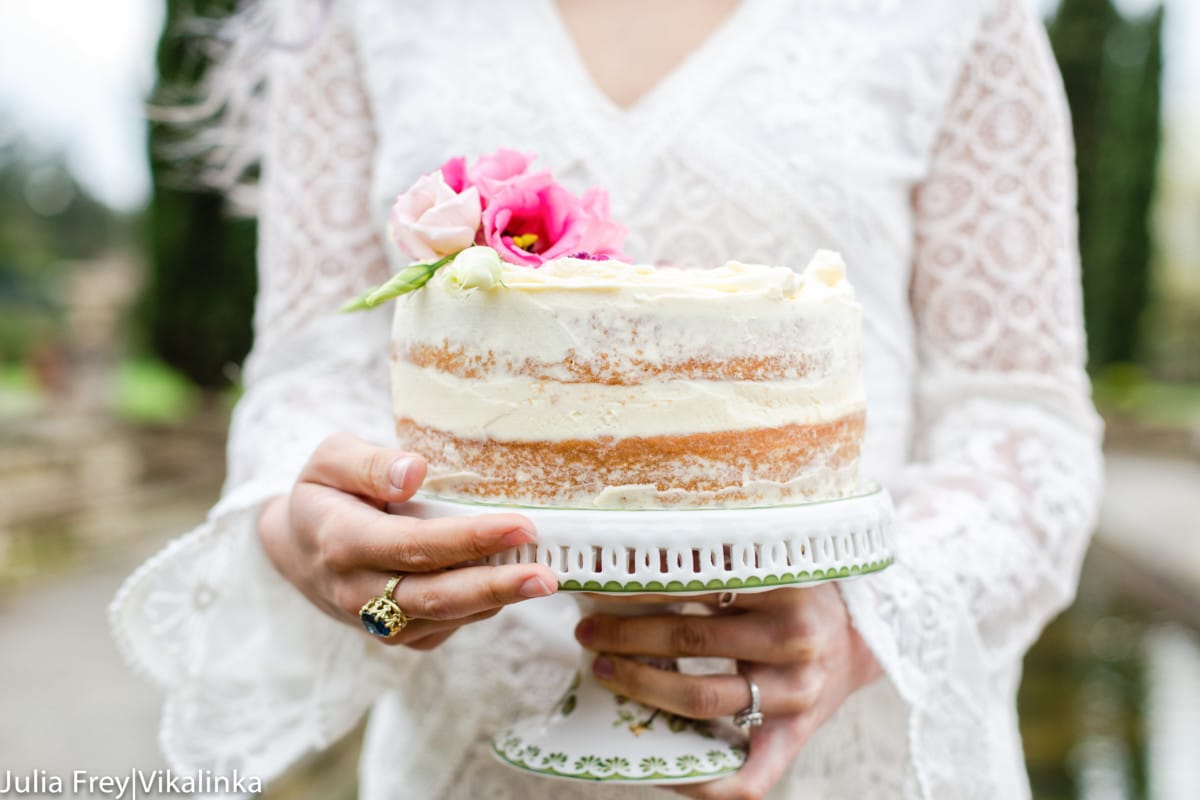 Woman holding a cake on a stand