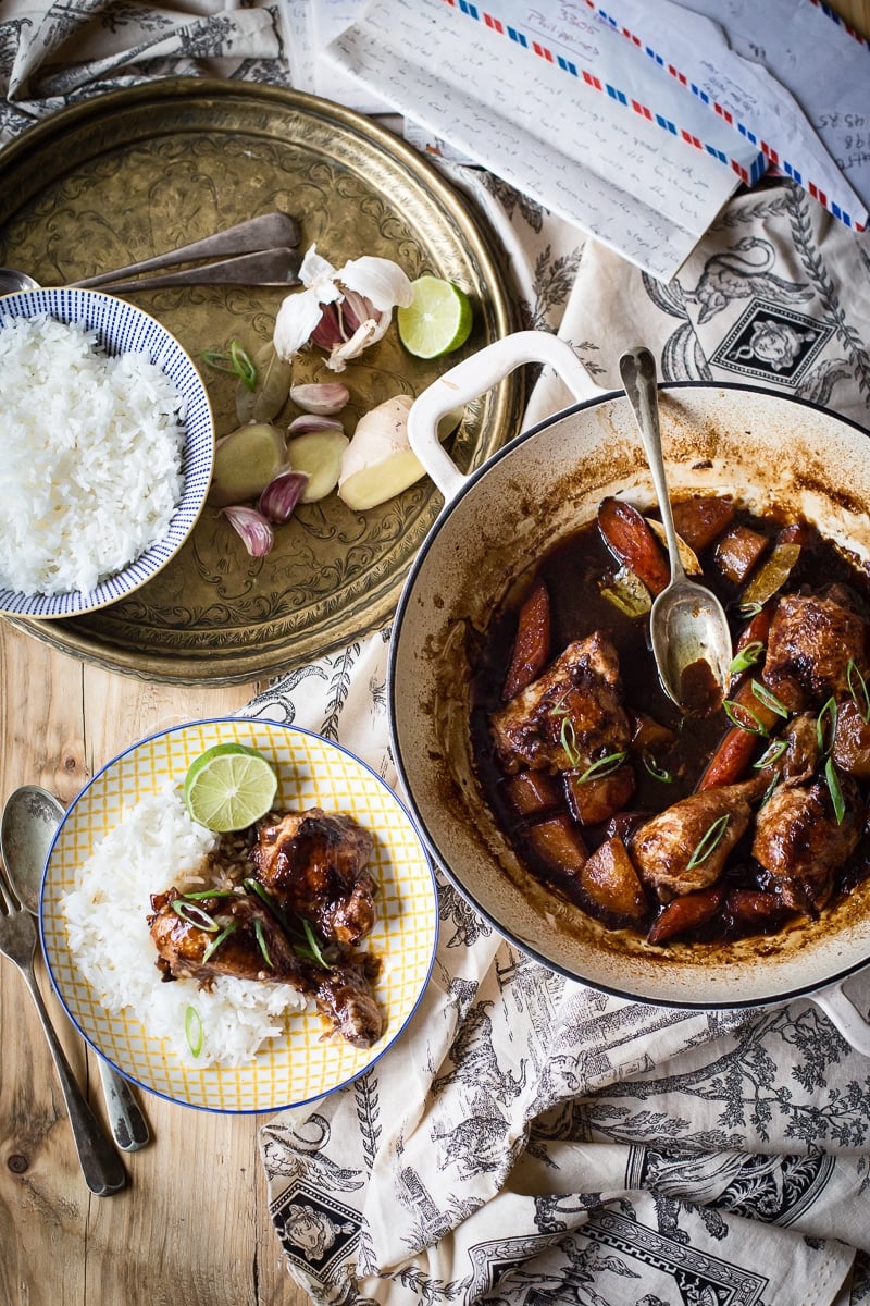 Table setting with the stew in a pot and on a plate with rice