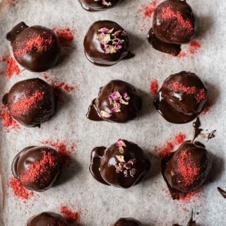 Cake Truffles dipped in chocolate with strawberry dust and rose petals