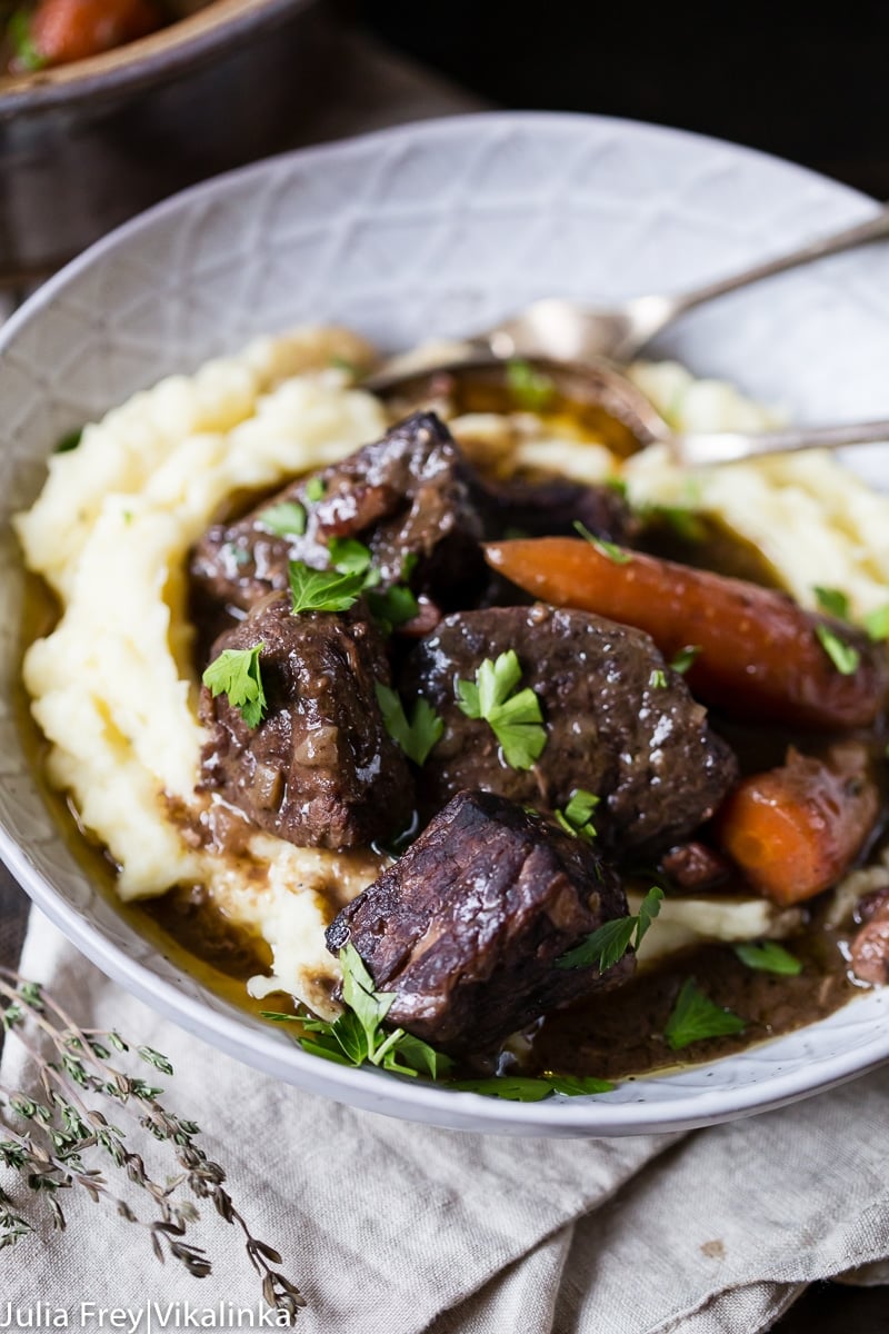 Beef Bourguignon in a bowl with mashed potatoes