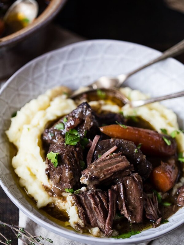 Bowl with the stew on mashed potatoes with cutlery