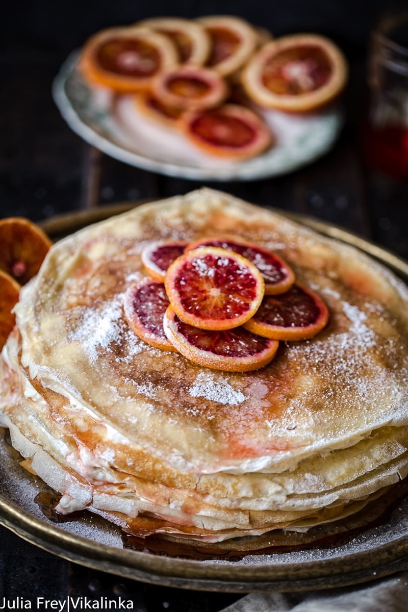 Crepe cake topped with sliced blood oranges