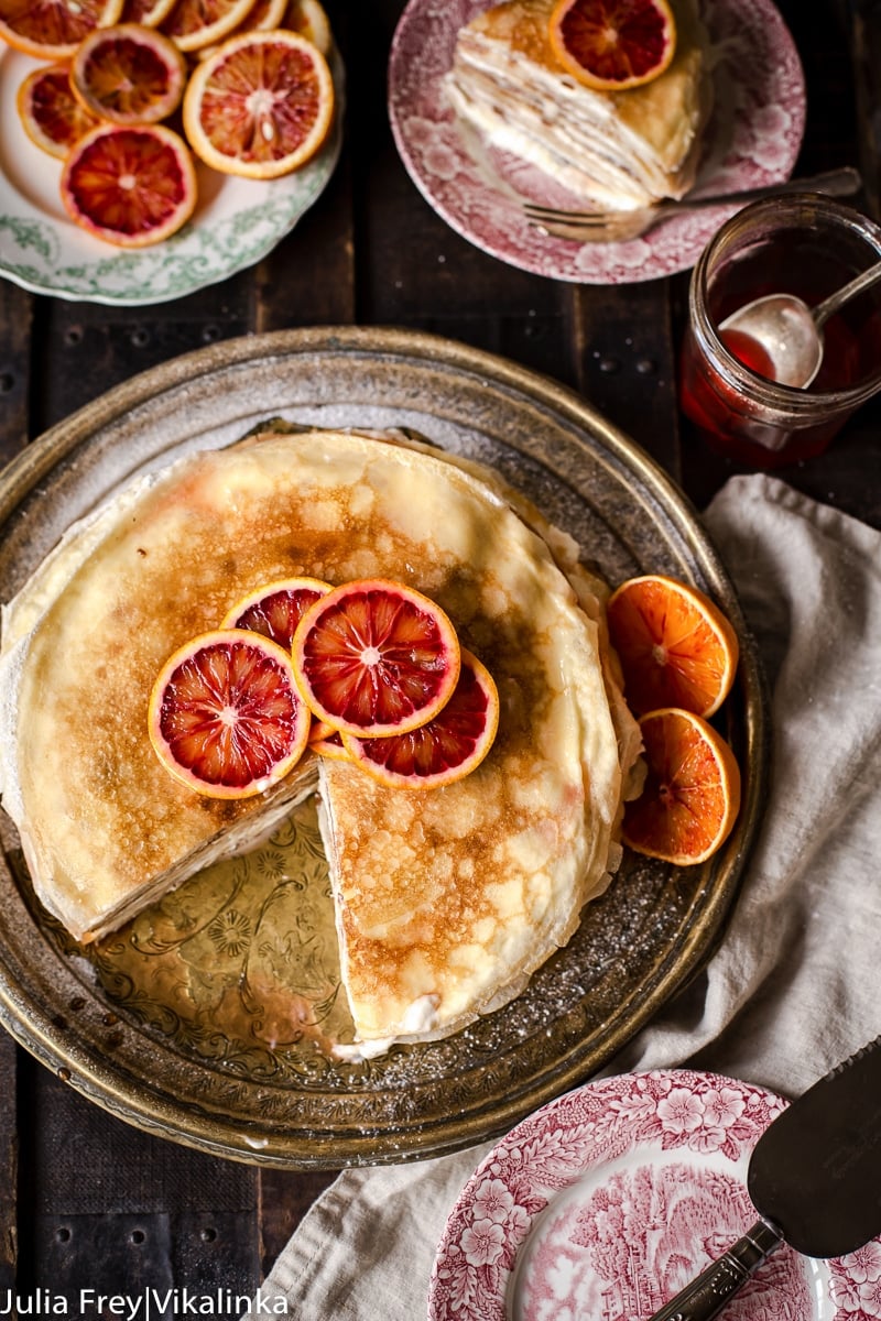 top down view of crepe cake topped with sliced blood oranges